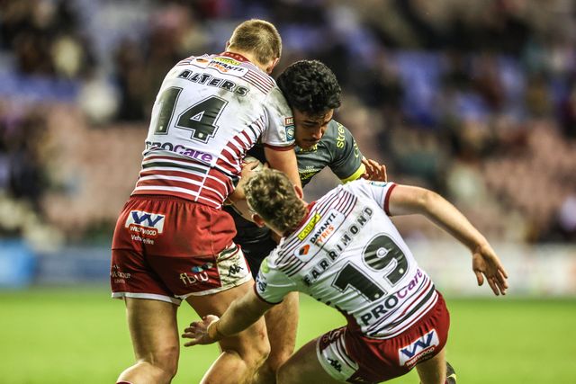 Keenan Palasia of Leeds Rhinos is tackled by Kaide Ellis of Wigan Warriors and Jack Farrimond of Wigan Warriors during the Betfred Super League round 11 match Wigan Warriors vs Leeds Rhinos at The Brick Community Stadium, Wigan, United Kingdom on 15 May 2026

(Photo by Alfie Cosgrove/News Images)