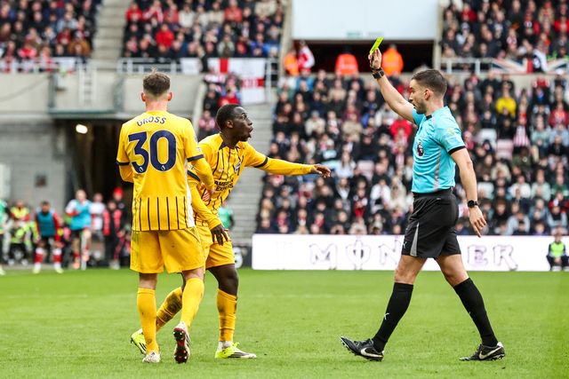 Referee Thomas Kirk gives a yellow card to Yankuba Minteh of Brighton & Hove Albion during the Premier League match Sunderland vs Brighton & Hove Albion at Stadium Of Light, Sunderland, United Kingdom on 14 March 2026

(Photo by Alfie Cosgrove/News Images)