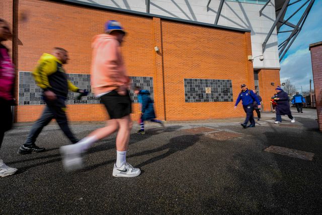A general view shows fans walking past  the ‘our blue and amber’ memorial wall a the stadium during the Betfred Super League round 1 match Leeds Rhinos vs Warrington Wolves at AMT Headingley Stadium, Leeds, United Kingdom on 29 March 2026

(Photo by Maynard Manyowa/News Images)