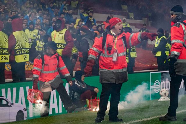 Stewards battle to contain flares thrown on to the pitch prior to kick off during the UEFA Europa League 
Knockout Round Play-offs match Nottingham Forest vs Fenerbahce at City Ground, Nottingham, United Kingdom on 26 February 2026

(Photo by Maynard Manyowa/News Images)