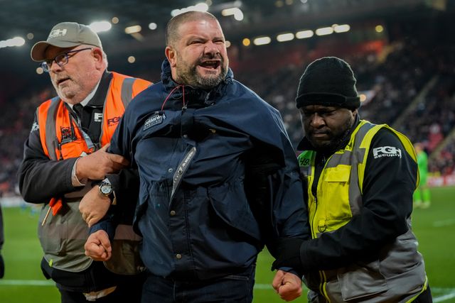 A pitch invader celebrates Yuki Ohashi of Blackburn Rovers scoring to make it 0-2 as security tries to remove him from the pitch during the Sky Bet Championship match Sheffield United vs Blackburn Rovers at Bramall Lane, Sheffield, United Kingdom on 22 April 2026

(Photo by Maynard Manyowa/News Images)