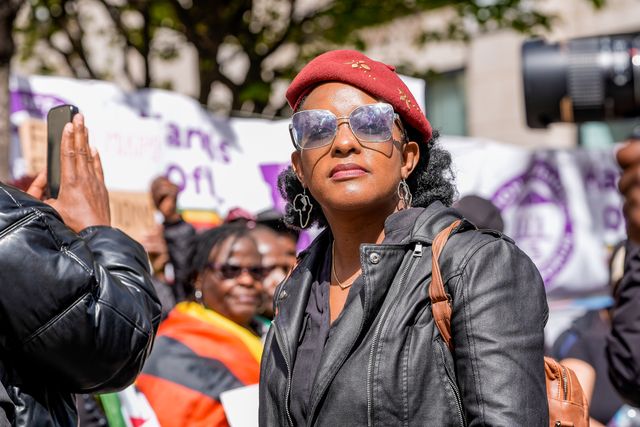 Development economist and activist Chenayi Mutambasere  looks on during Zimbabweans protest against the proposed constitution amendment at Embassy of Zimbabwe, London, United Kingdom on 18 April 2026

(Photo by Maynard Manyowa/News Images)