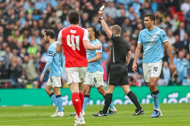 Referee Peter Bankes gives a yellow card to Abdukodir Khusanov of Manchester City of Manchester City during the Carabao Cup Final match Arsenal vs Manchester City at Emirates, London, United Kingdom on 22 March 2026

(Photo by Alfie Cosgrove/News Images)