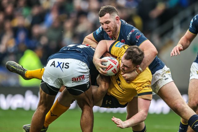 Sam Hall of Castleford Tigers is tackled by Kallum Watkins of Leeds Rhinos and Cameron Smith of Leeds Rhinos during the Betfred Super League round 4 match Leeds Rhinos vs Castleford Tigers at AMT Headingley Stadium, Leeds, United Kingdom on 08 March 2026

(Photo by Alfie Cosgrove/News Images)