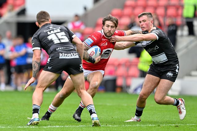 Joe Shoroocks of Salford Red Devils gets tackled by Jordan Lane and Will Gardiner of Hull FC during the Betfred Super League Round 16 match Salford Red Devils vs Hull FC at Salford Community Stadium, Eccles, United Kingdom, 7th July 2024

(Photo by Cody Froggatt/News Images)