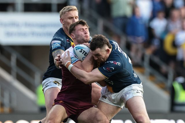 Connor Carr of Huddersfield Giants is tackled by Cameron Smith of Leeds Rhinos and Mikolaj Oledzki of Leeds Rhinos during the Betfred Super League round 12 match Leeds Rhinos vs Huddersfield Giants at AMT Headingley Stadium, Leeds, United Kingdom on 22 May 2026

(Photo by Mark Cosgrove/News Images)