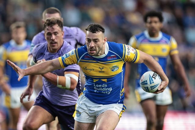 Jake Connor of Leeds Rhinos hands off Jack Broadbent of Hull KR to power on through to go over for a try during the Betfred Super League round 23 match Leeds Rhinos vs Hull KR at Headingley Stadium, Leeds, United Kingdom, 21st August 2025

(Photo by Mark Cosgrove/News Images)