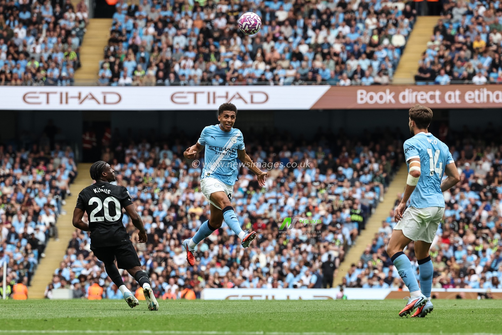 Rico Lewis of Manchester City jumps up to win the high ball during the Premier League match Manchester City vs Tottenham Hotspur at Etihad Stadium, Manchester, United Kingdom, 23rd August 2025

(Photo by Mark Cosgrove/News Images)