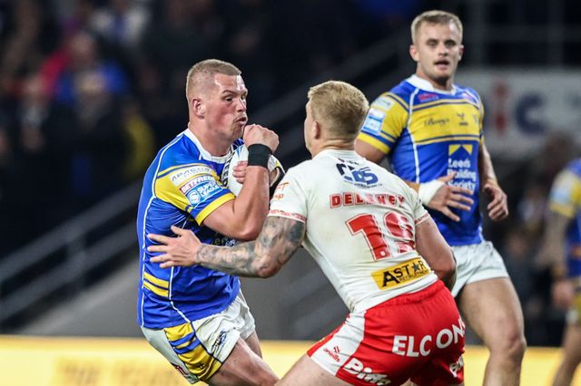 Tom Holroyd of Leeds Rhinos is tackled by George Delaney of St. Helens during the Betfred Super League play-off Eliminator 1 match Leeds Rhinos vs St Helens at Headingley Stadium, Leeds, United Kingdom, 27th September 2025

(Photo by Alfie Cosgrove/News Images)