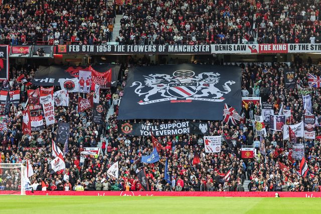 Manchester United fans hold up flags before the game during the Premier League match Manchester United vs Brentford at Old Trafford, Manchester, United Kingdom on 27 April 2026

(Photo by Mark Cosgrove/News Images)