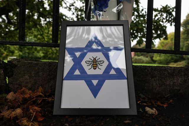 A Star of David with a Manchester Bee in a photo frame is placed at the scene during the Manchester synagogue terror attack day 2 at Heaton Park Shul, Manchester, United Kingdom, 3rd October 2025

(Photo by Mark Cosgrove/News Images)