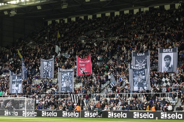Newcastle fans hold up flags of former players as they show racism the red card during the Premier League match Newcastle Untied vs Bournemouth at St. James's Park, Newcastle, United Kingdom on 18 April 2026

(Photo by Mark Cosgrove/News Images)