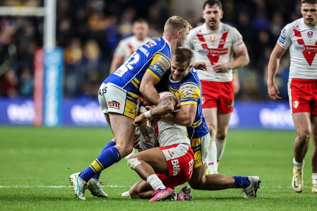 Tristan Sailor of St. Helens is tackled by James McDonnell of Leeds Rhinos and Cooper Jenkins of Leeds Rhinos during the Betfred Super League play-off Eliminator 1 match Leeds Rhinos vs St Helens at Headingley Stadium, Leeds, United Kingdom, 27th September 2025

(Photo by Alfie Cosgrove/News Images)