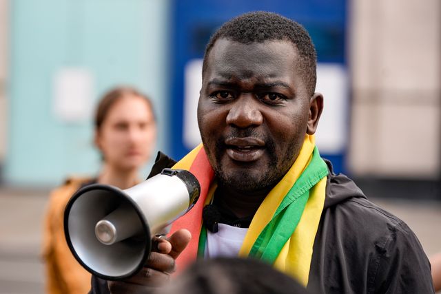 Former political detainee and youth activist Makomborero Haruzvishe speaks during Zimbabweans protest against the proposed constitution amendment at Embassy of Zimbabwe, London, United Kingdom on 18 April 2026

(Photo by Maynard Manyowa/News Images)