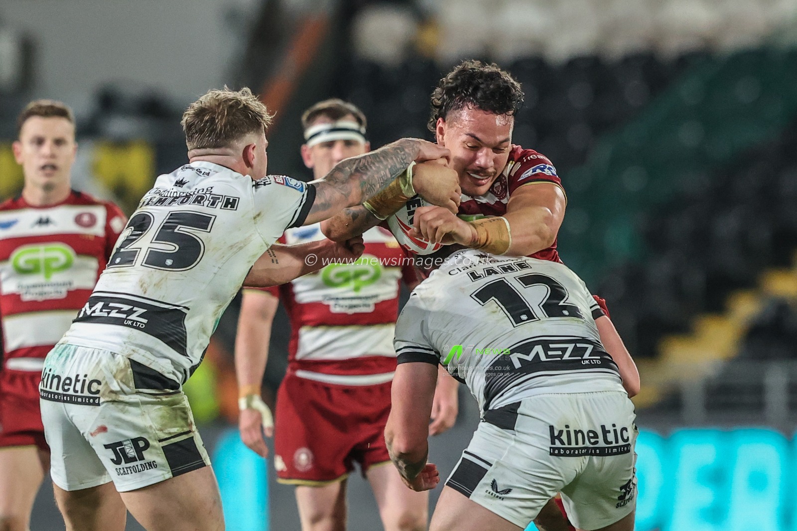 Tyler Dupree of Wigan Warriors is tackled by Denive Balmforth of Hull FC and Jordan Lane of Hull FC during the Betfred Super League Round 2 match Hull FC vs Wigan Warriors at MKM Stadium, Hull, United Kingdom, 21st February 2025

(Photo by Alfie Cosgrove/News Images)