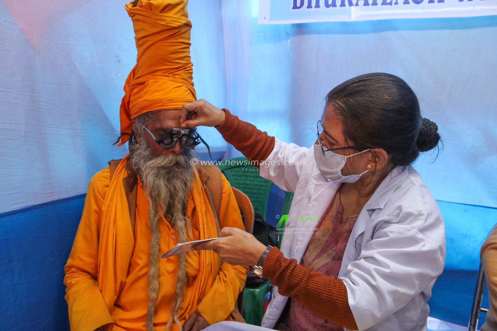 A doctor examines the eye of a Sadhu or Hindu holy man, at a free eye camp at a Gangasagar mela transit camp in Kolkata,India on January 11,2025.Picture by Debajyoti Chakraborty.(Photo: Debajyoti Chakraborty/News Images)