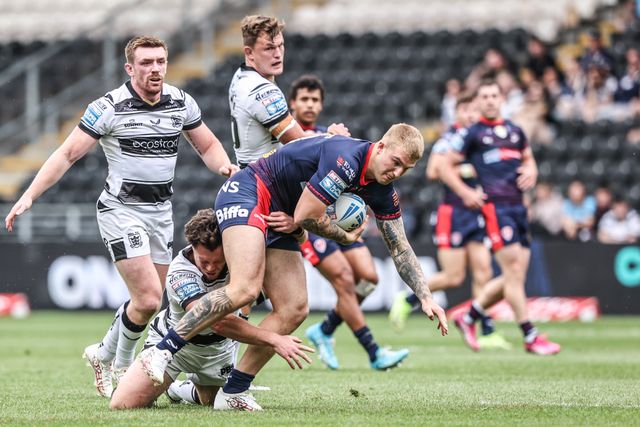 George Delaney of St. Helens is tackled during the Betfred Super League round 17 match Hull FC vs St Helens at MKM Stadium, Hull, United Kingdom, 5th July 2025

(Photo by Alfie Cosgrove/News Images)
