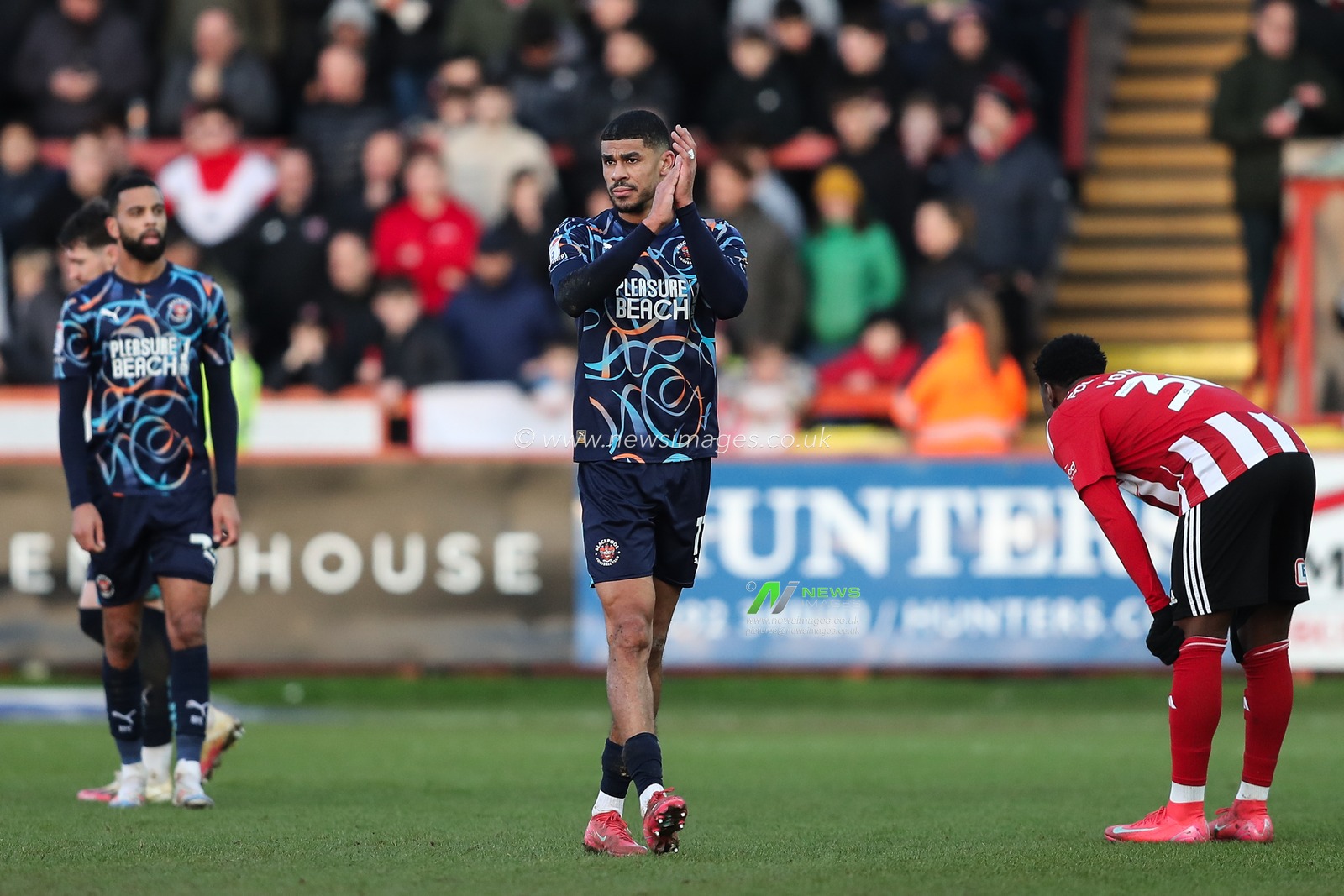 Ashley Fletcher of Blackpool applauds the travelling fans during the Sky Bet League 1 match Exeter City vs Blackpool at St James' Park, Exeter, United Kingdom, 25th January 2025

(Photo by Gareth Evans/News Images)