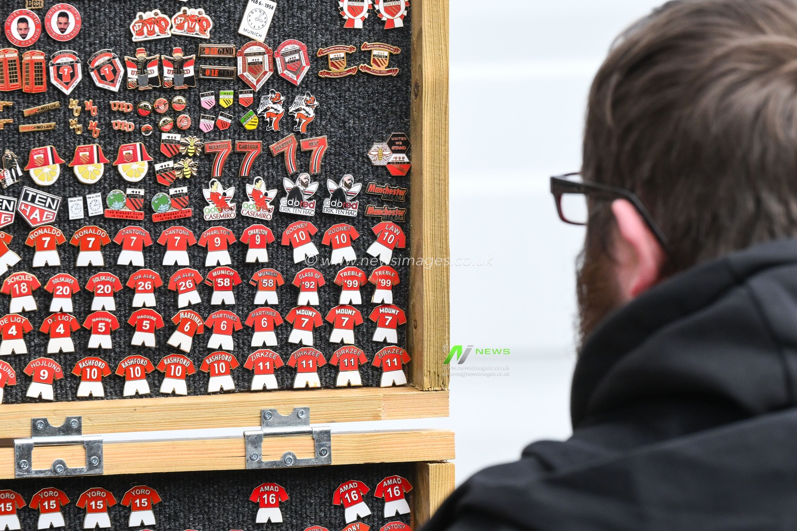 A fan looks at the pin badges on a stall ahead of the Emirates FA Cup 5th Round match Manchester United vs Fulham at Old Trafford, Manchester, United Kingdom, 2nd March 2025

(Photo by Craig Thomas/News Images)
