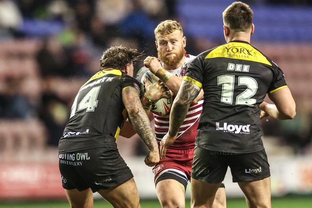 Luke Thompson of Wigan Warriors is tackled by Denive Balmforth of York Knights and Jesse Dee of York Knights during the Betfred Super League round 5 match Wigan Warriors vs York Knights at The Brick Community Stadium, Wigan, United Kingdom on 19 March 2026

(Photo by Alfie Cosgrove/News Images)