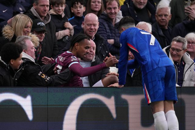 Pedro Neto of Chelsea helps Lucas Pires of Burnley up after falling into crowd during the Premier League match Chelsea vs Burnley at Stamford Bridge, London, United Kingdom on 21 February 2026

(Photo by Harvey Murphy/News Images)