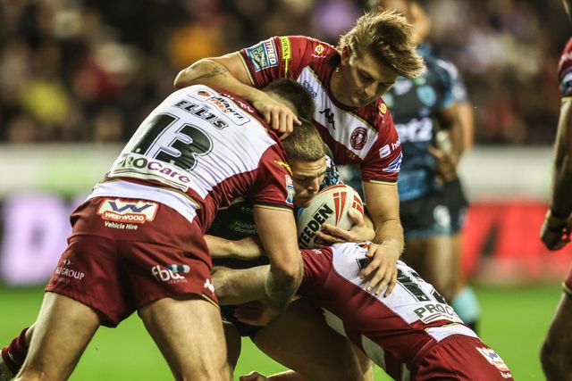 Bailey Hodgson of Leigh Leopards is tackled by Kaide Ellis of Wigan Warriors and Liam Farrell of Wigan Warriors during the Betfred Super League Semi Final 1 match Wigan Warriors vs Leigh Leopards at The Brick Community Stadium, Wigan, United Kingdom, 3rd October 2025

(Photo by Alfie Cosgrove/News Images)