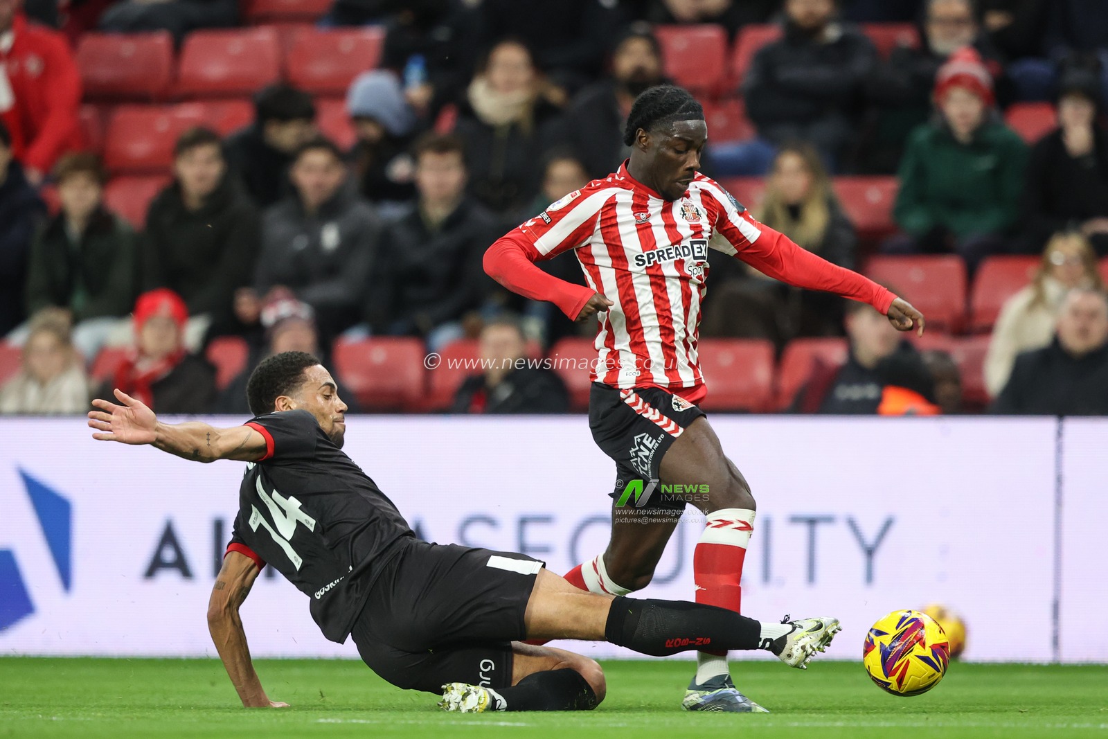 Eliezer Mayenda of Sunderland is fouled by Zak Vyner of Bristol City during the Sky Bet Championship match Sunderland vs Bristol City at Stadium Of Light, Sunderland, United Kingdom, 10th December 2024

(Photo by Alfie Cosgrove/News Images)