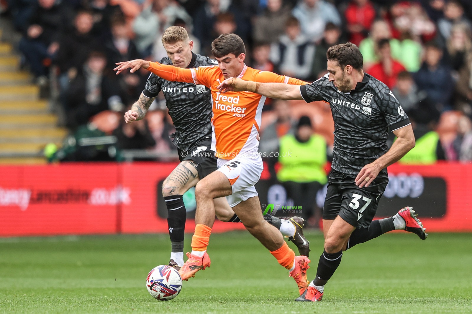 Rob Apter of Blackpool and Matthew James of Wrexham battle for the ball during the Sky Bet League 1 match Blackpool vs Wrexham at Bloomfield Road, Blackpool, United Kingdom, 21st April 2025

(Photo by Alfie Cosgrove/News Images)