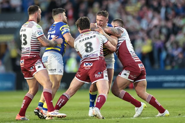 Ben Currie of Warrington Wolves is tackled by Ethan Havard of Wigan Warriors during the Betfred Super League round 9 match Warrington Wolves vs Wigan Warriors at The Halliwell Jones Stadium, Warrington, United Kingdom on 24 April 2026

(Photo by Mark Cosgrove/News Images)