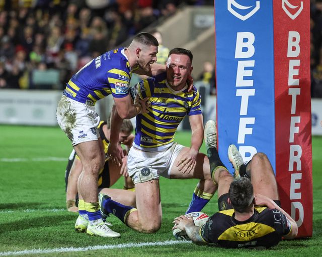 Ben Currie celebrates his 100th Warrington Wolves try with team mates during the Betfred Super League Round 4 match York Knights vs Warrington Wolves at LNER Community Stadium, York, United Kingdom on 06 March 2026

(Photo by Mark Cosgrove/News Images)