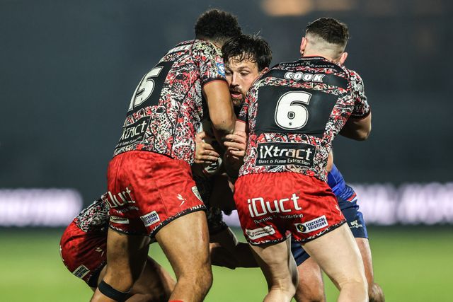 Tyson Smoothy of Wakefield Trinity is tackled by Jacob Alick-Wiencke of Leigh Leopards and Adam Cook of Leigh Leopards during the Betfred Super League round 5 match Wakefield Trinity vs Leigh Leopards at DIY Kitchens Stadium, Wakefield, United Kingdom on 20 March 2026

(Photo by Alfie Cosgrove/News Images)
