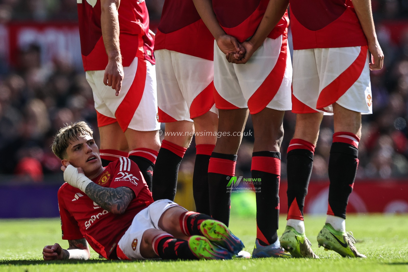 Alejandro Garnacho of Manchester United lays down behind the wall for a free kick during the Premier League match Manchester United vs Wolverhampton Wanderers at Old Trafford, Manchester, United Kingdom, 20th April 2025

(Photo by Mark Cosgrove/News Images)