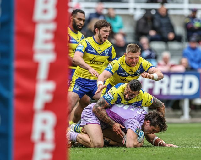 Patrick Mago of Wigan Warriors is tackled by Paul Vaughan of Warrington Wolves during the Betfred Magic Weekend 2025 match Huddersfield Giants vs Hull FC at St. James's Park, Newcastle, United Kingdom, 4th May 2025

(Photo by Mark Cosgrove/News Images)