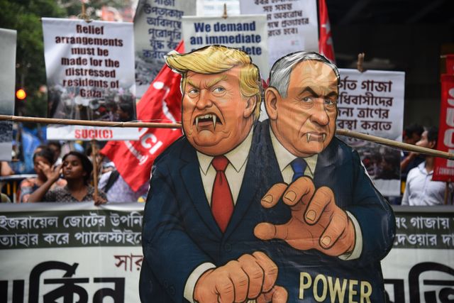 Activists of Social Unity Center of India (SUCI) hold placards and an effigy of US President Donald Trump and Israel's Prime Minister Benjamin Netanyahu during a protest against Western policy in the Israel-Hamas conflict, near US Embassy in Kolkata, Eastern India, 07 October 2025.Photo by Debajyoti Chakraborty.(Photo: Debajyoti Chakraborty/News Images)