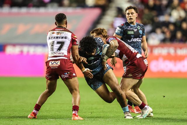 Alec Tuitavake of Leigh Leopards is tackled by Adam Keighran of Wigan Warriors during the Betfred Super League Semi Final 1 match Wigan Warriors vs Leigh Leopards at The Brick Community Stadium, Wigan, United Kingdom, 3rd October 2025

(Photo by Alfie Cosgrove/News Images)