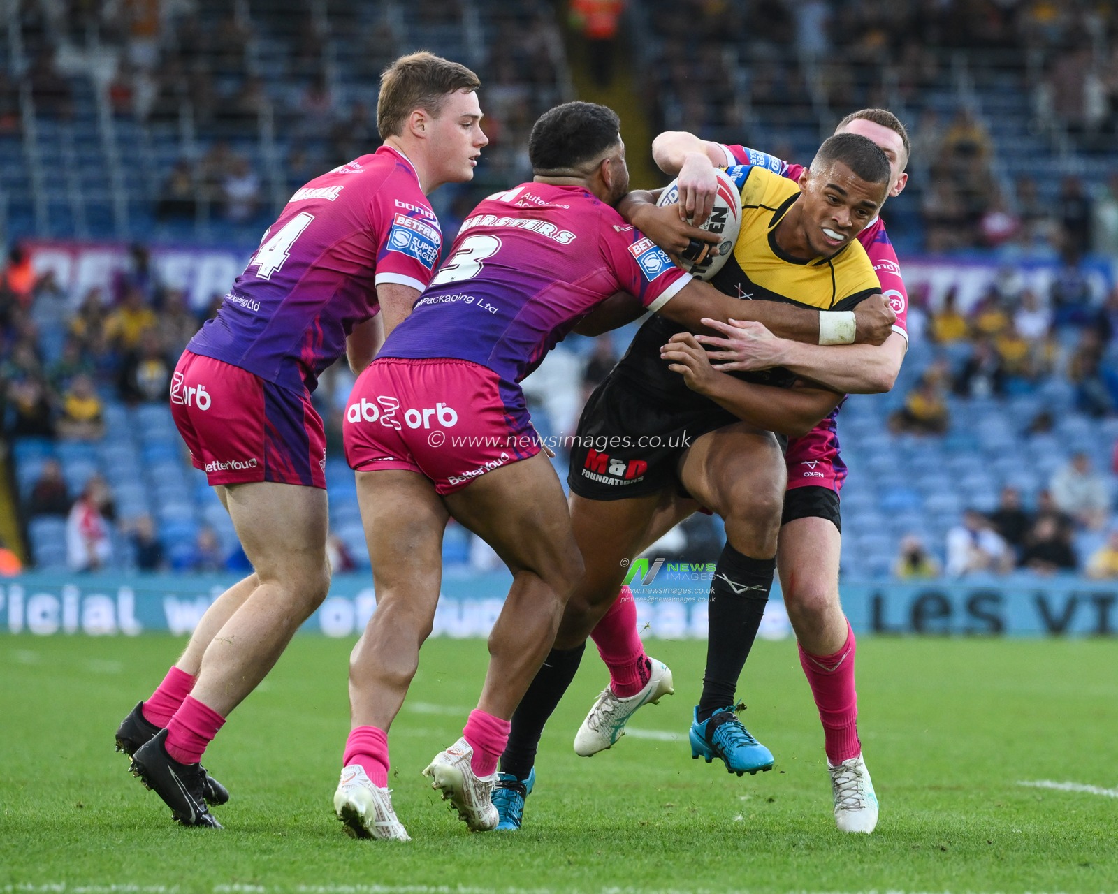 Corey Hall of Castleford Tigers is tackled by Olly Russell of Huddersfield Giants and Esan Marsters of Huddersfield Giants during the Magic Weekend match Huddersfield Giants vs Castleford Tigers at Elland Road, Leeds, United Kingdom, 18th August 2024

(Photo by Craig Thomas/News Images)