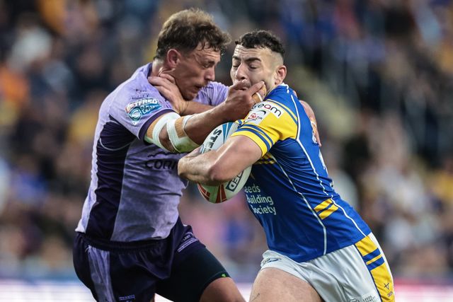 Jake Connor of Leeds Rhinos hands off Jack Broadbent of Hull KR to power on through to go over for a try during the Betfred Super League round 23 match Leeds Rhinos vs Hull KR at Headingley Stadium, Leeds, United Kingdom, 21st August 2025

(Photo by Mark Cosgrove/News Images)
