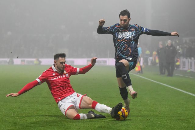 James Husband of Blackpool is tackled by Ryan Barnett of Wrexham during the Sky Bet League 1 match Wrexham vs Blackpool at SToK Cae Ras, Wrexham, United Kingdom, 26th December 2024

(Photo by Craig Thomas/News Images)