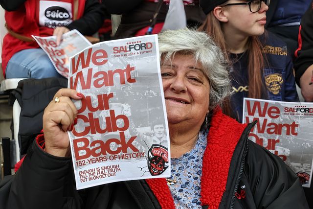 Salford Red Devils fans protest holding up a signs saying “We want out club back” during the Betfred Super League Round 23 match Leigh Leopards vs Salford Red Devils at Leigh Sports Village, Leigh, United Kingdom, 22nd August 2025

(Photo by Mark Cosgrove/News Images)