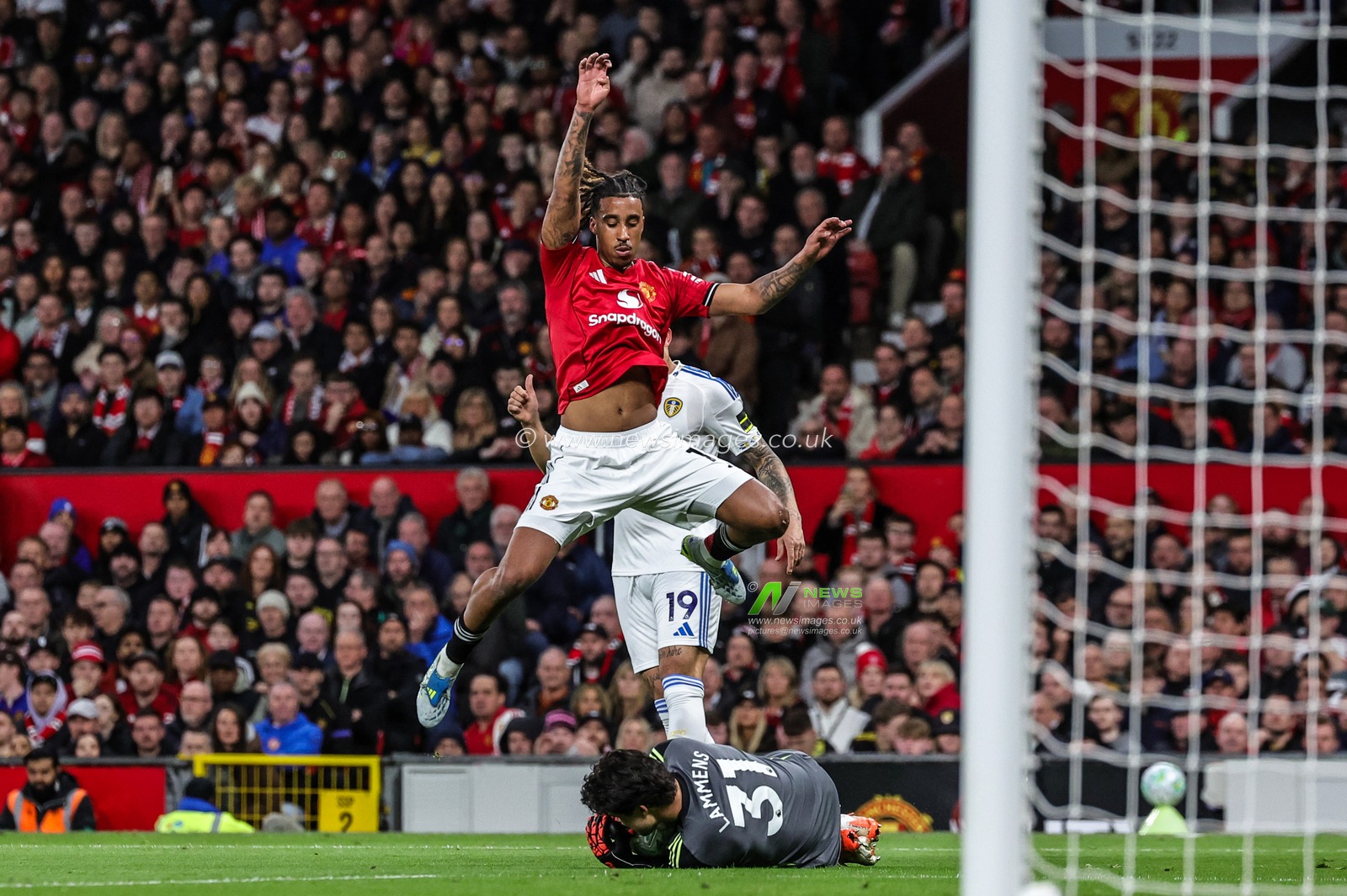 Leny Yoro of Manchester United jumps over Manchester United goalkeeper Senne Lammens as he collects the ball during the Premier League match Manchester United vs Leeds United at Old Trafford, Manchester, United Kingdom on 13 April 2026

(Photo by Mark Cosgrove/News Images)