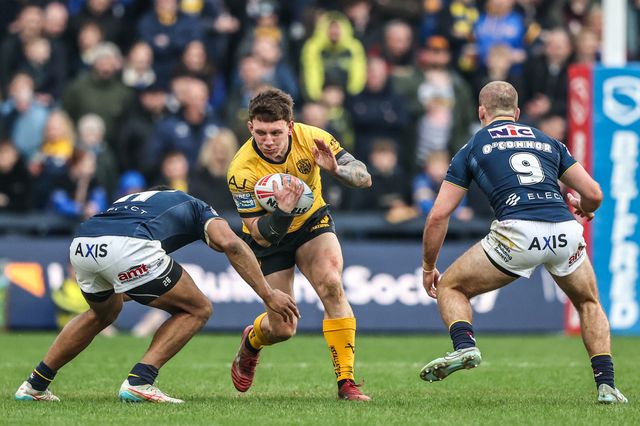 George Lawler of Castleford Tigers is tackled by Kallum Watkins of Leeds Rhinos and Jarrod O'Connor of Leeds Rhinos during the Betfred Super League round 4 match Leeds Rhinos vs Castleford Tigers at AMT Headingley Stadium, Leeds, United Kingdom on 08 March 2026

(Photo by Alfie Cosgrove/News Images)