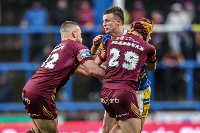 Ash Handley of Leeds Rhinos is tackled by Sam Hewitt of Huddersfield Giants and George Flanagan  of Huddersfield Giants during the Betfred Super League Round 8 match Leeds Rhinos vs Huddersfield Giants at Headingley Stadium, Leeds, United Kingdom, 18th April 2025

(Photo by Alfie Cosgrove/News Images)