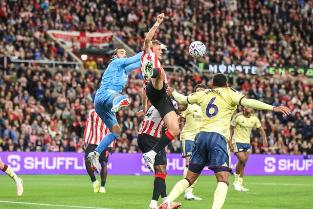 Arsenal goalkeeper David Raya and Daniel Ballard of Sunderland battle for the high ball during the Premier League match Sunderland vs Arsenal at Stadium Of Light, Sunderland, United Kingdom on 12 September 2026

(Photo by Alfie Cosgrove/News Images)
