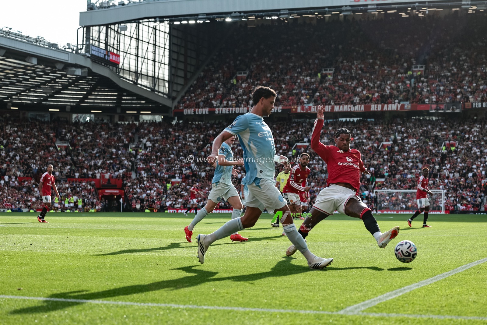 Ruben Dias of Manchester City clears the ball up field under pressure from Marcus Rashford of Manchester United during the Premier League match Manchester United vs Manchester City at Old Trafford, Manchester, United Kingdom on 13 September 2026

(Photo by Mark Cosgrove/News Images)