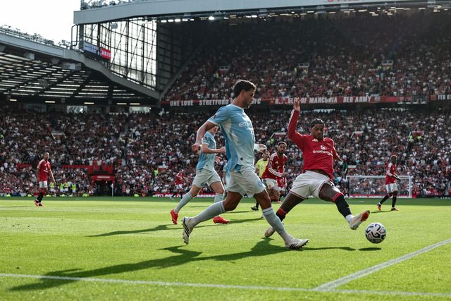 Ruben Dias of Manchester City clears the ball up field under pressure from Marcus Rashford of Manchester United during the Premier League match Manchester United vs Manchester City at Old Trafford, Manchester, United Kingdom on 13 September 2026

(Photo by Mark Cosgrove/News Images)