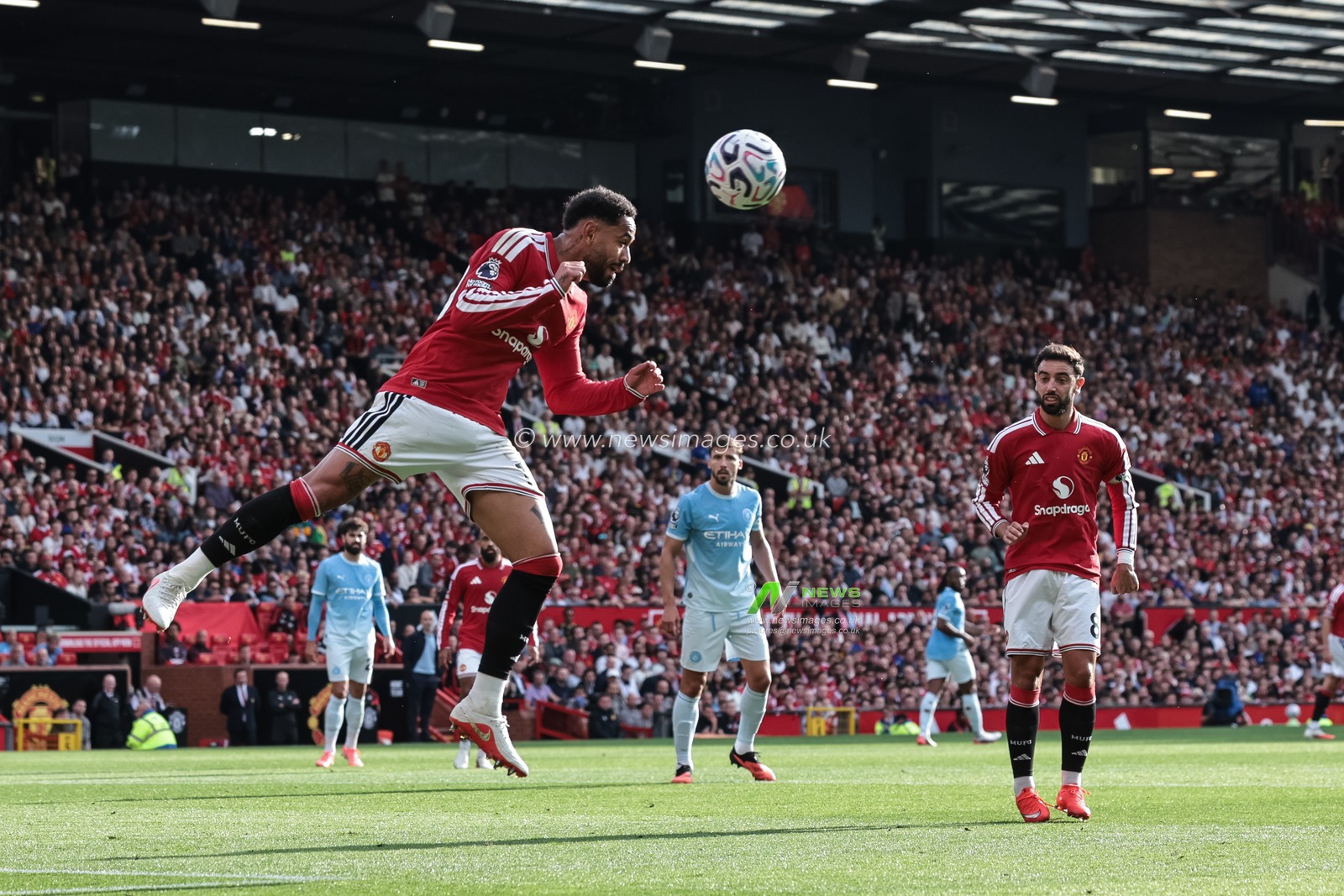 Matheus Cunha of Manchester United heads the ball clear of his defensive area during the Premier League match Manchester United vs Manchester City at Old Trafford, Manchester, United Kingdom on 13 September 2026

(Photo by Mark Cosgrove/News Images)