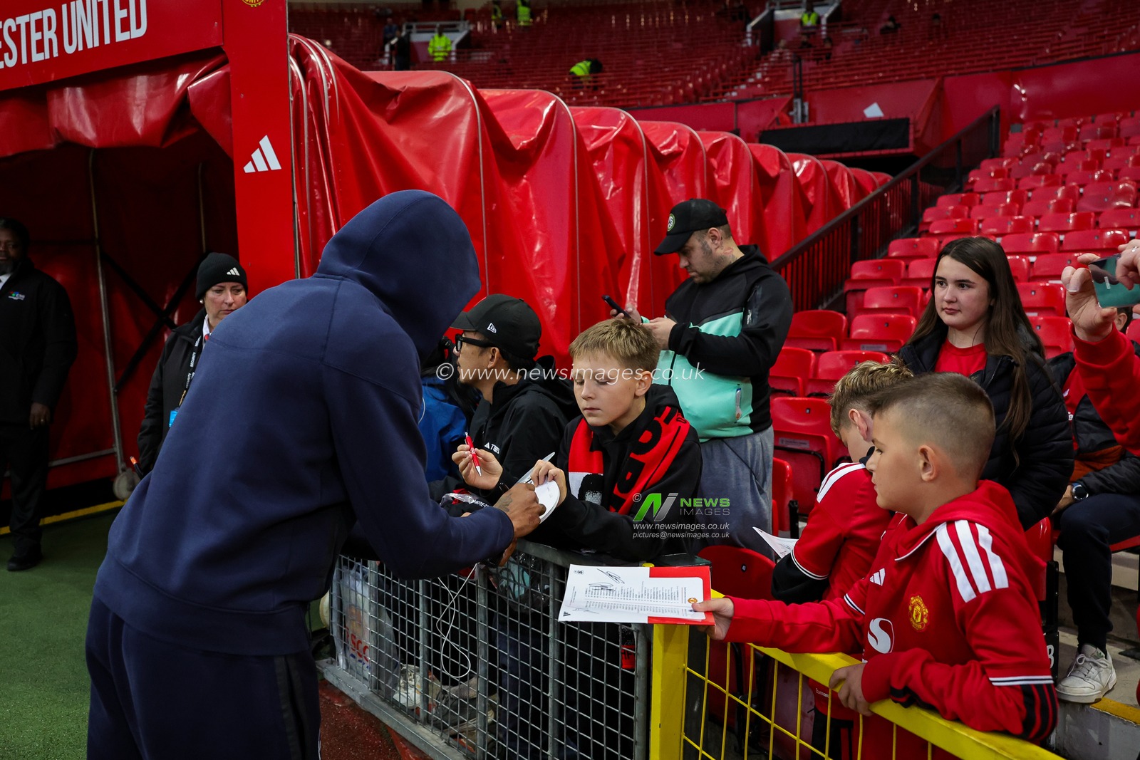 Georginio Rutter of Brighton & Hove Albion signs autographs for young fans during the Carabao Cup round 3 match Manchester United vs Brighton & Hove Albion at Old Trafford, Manchester, United Kingdom on 16 September 2026

(Photo by Mark Cosgrove/News Images)