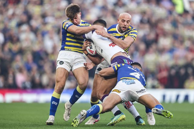 Corey Hall of Wakefield Trinity is tackled by Ewan Irwin of Warrington Wolves, James Harrison of Warrington Wolves and Albert Hopoate of Warrington Wolves during the Betfred Super League Grand Final match Warrington Wolves vs Wakefield Trinity at Old Trafford, Manchester, United Kingdom on 03 October 2026

(Photo by Alfie Cosgrove/News Images)