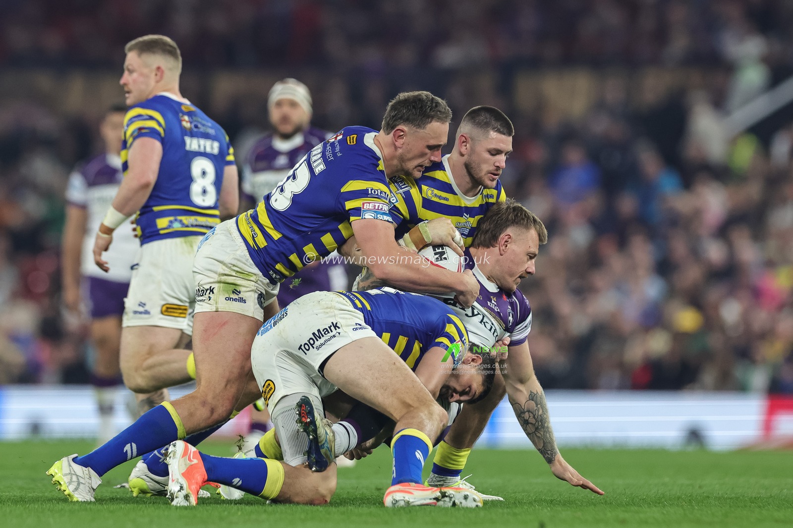 Tom Johnstone of Wakefield Trinity is tackled by Sam Stone of Warrington Wolves Ben Currie of Warrington Wolves and Danny Walker of Warrington Wolves during the Betfred Super League Grand Final match Warrington Wolves vs Wakefield Trinity at Old Trafford, Manchester, United Kingdom on 03 October 2026

(Photo by Mark Cosgrove/News Images)