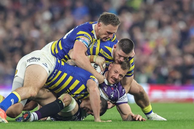 Tom Johnstone of Wakefield Trinity is tackled by Sam Stone of Warrington Wolves Ben Currie of Warrington Wolves and Danny Walker of Warrington Wolves during the Betfred Super League Grand Final match Warrington Wolves vs Wakefield Trinity at Old Trafford, Manchester, United Kingdom on 03 October 2026

(Photo by Mark Cosgrove/News Images)